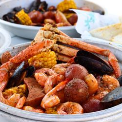 New Cajun Boil. Made with a Snow Crab, shrimp, mussels, sausage, corn, potatoes, and bagettes.