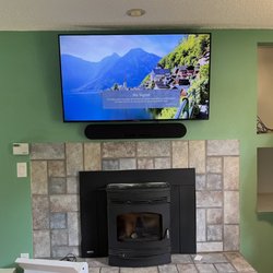 Krodan Tech - TV mounted above fireplace with Soundbar mounting.