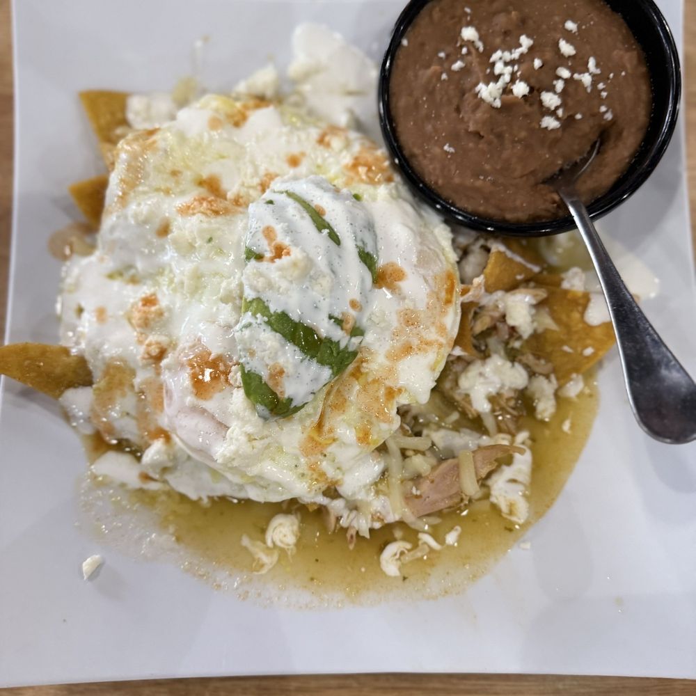 Good Day Cafe - Chilaquiles with salsa verde refried beans. - Breakfast & Brunch Near Me - Arlington, Texas Good Day Cafe - Chilaquiles with salsa verde refried beans. - Breakfast & Brunch Near Me - Arlington, Texas