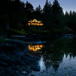 Gowlland Harbour Resort - View of the resort's boutique hotel at night from the water.