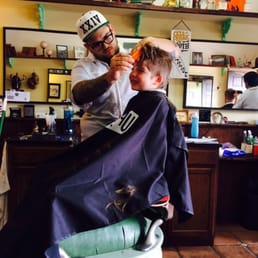 Getting his hipster cut with a smile!!!