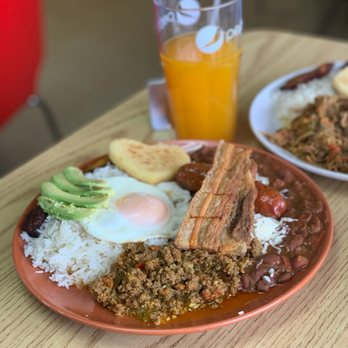 La Taguara - two plates of food on a table - Venezuelan Near Me - Madison, Wisconsin La Taguara - two plates of food on a table - Venezuelan Near Me - Madison, Wisconsin
