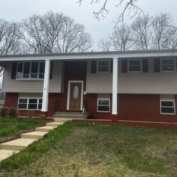 J Serino Inspections - A two-story home with a brick and siding exterior, a front porch with tall white columns, and a front yard with a stone path ...