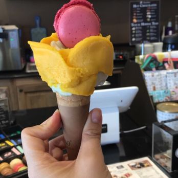 Amorino Gelato - My gelato flavors were mango (which is pretty popular), lime and basil and passion fruit!! Topped with a raspberry macaroon! - Desserts Near Me - Atlanta, Georgia