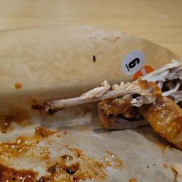 Half eaten chicken wings combo complete with flies.
