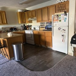 Mountain View Villa Apartments - See worn cabinets and pieces of 2x4 holding kitchen counters up. This is just the tip of the iceberg on how badly these things are