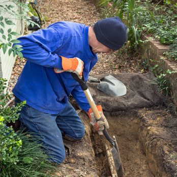 Environmental Designers Irrigation - An irrigation installer digging a trench in a garden landscape to lay down underground sprinkler system lines. - Irrigation Near Me - Wall Township, New Jersey Environmental Designers Irrigation - An irrigation installer digging a trench in a garden landscape to lay down underground sprinkler system lines. - Irrigation Near Me - Wall Township, New Jersey