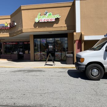 Jamaican Flavors - a white van parked in front of a restaurant - Caribbean Near Me - Snellville, Georgia