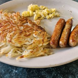 Oasis Restaurant & Motel - Hash browns, sausage links and scrambled eggs with toast.