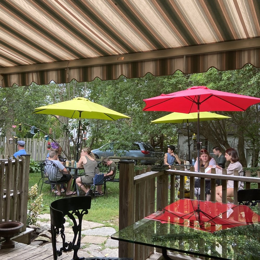 a patio with tables and umbrellas
