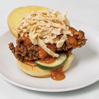Trixie’s Chicken - buttermilk brined chicken thigh sandwich with coleslaw, pickles, and hot honey garlic sauce - Chicken Shop Near Me Trixie’s Chicken - buttermilk brined chicken thigh sandwich with coleslaw, pickles, and hot honey garlic sauce - Chicken Shop Near Me
