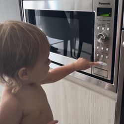 Onni South Lake Union - Toddler programming a microwave