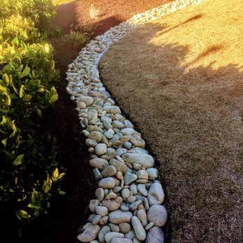 Pro Cuts Lawn Service - River rock border professionally install to existing or new landscapes. - Landscaping Near Me Pro Cuts Lawn Service - River rock border professionally install to existing or new landscapes. - Landscaping Near Me