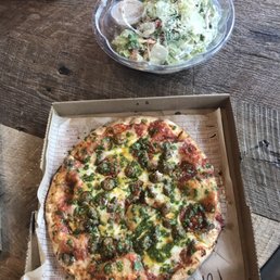 The pizza - topped with pesto - and the salad
