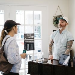 Sipple - Owner, Danny, chatting with a customer at the checkout.