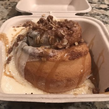 Cinnaholic - Customized roll with amaretto frosting, caramel sauce, and pie crumble topping. It looks messy because it's fresh from the oven and hot. - Bakeries Near Me - Henderson, Nevada