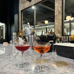 two glasses of wine on a bar