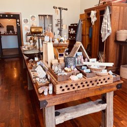 Maker. - Main center table filled with various local /US made hand made jewelries, lotions, candles, perfumes, and self-care products.