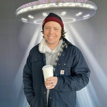Bean Me Up Roastery - Cute husband in front of cute photo-op wall. - Coffee Roasteries Near Me - Munster, Indiana