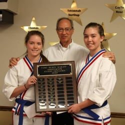 Vero Beach Karate Association - 2 students pose with head instructor Mr. Willis to receive the Student Excellence Award.