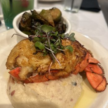 Papi Cuisine - JUMBO LUMP CRAB STUFFED LOBSTER Crab Stuffed Lobster with a butter drizzle & grilled lemon on the side with mash and Brussels - Cocktail Bars Near Me - Baltimore, Maryland