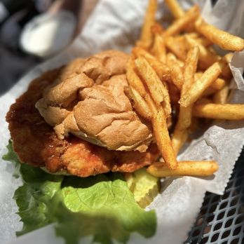 Trainwrecksaloon Westport - Buffalo chicken sandwich and seasoned fries - Bars Near Me - Saint Louis, Missouri Trainwrecksaloon Westport - Buffalo chicken sandwich and seasoned fries - Bars Near Me - Saint Louis, Missouri