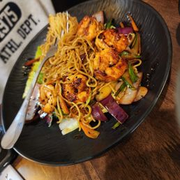 a plate of noodles with shrimp and vegetables a plate of noodles with shrimp and vegetables