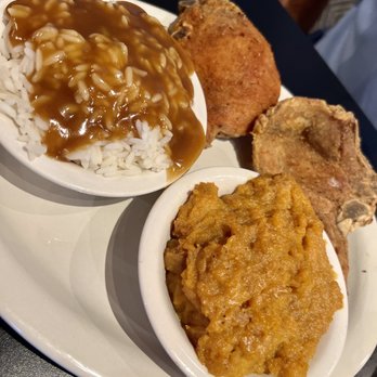 Kiki’s Chicken And Waffles - Fried pork chop with sweet potato soufflé and rice and gravy with a corn bread - Soul Food Near Me - Columbia, South Carolina Kiki’s Chicken And Waffles - Fried pork chop with sweet potato soufflé and rice and gravy with a corn bread - Soul Food Near Me - Columbia, South Carolina