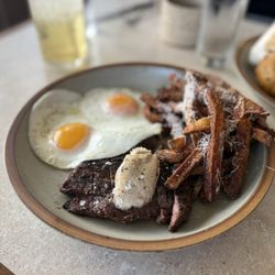 Uncle Wolfie’s Breakfast Tavern - Steak frites with 2 eggs. Perfectly cooked at medium rare. Nicely marinated steak.