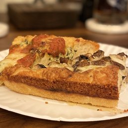 a slice of pizza on a paper plate