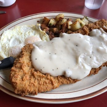 Rooster's - Close up on chicken fried steak. Comes with potatoes, eggs and toast! - American Near Me - Medford, Oregon Rooster's - Close up on chicken fried steak. Comes with potatoes, eggs and toast! - American Near Me - Medford, Oregon