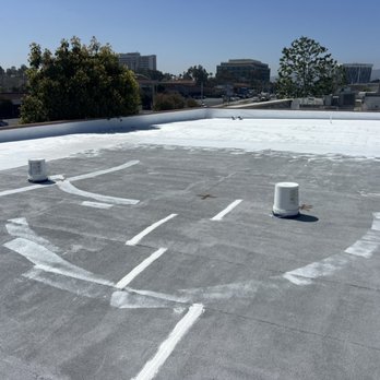 Roofing Systems Incorporated - Prepping roof with silicone coating over grey primer - Roofing Near Me - Los Angeles, California Roofing Systems Incorporated - Prepping roof with silicone coating over grey primer - Roofing Near Me - Los Angeles, California