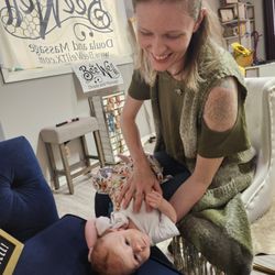 Interwoven Therapeutic - This is how she ended her 20 min infant massage, smiling at mom. While looking the direction that she didnt seem to like when we started.