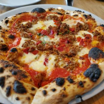 Vera - a pizza on a plate on a table - Pizza Near Me - Winnipeg, Manitoba Vera - a pizza on a plate on a table - Pizza Near Me - Winnipeg, Manitoba