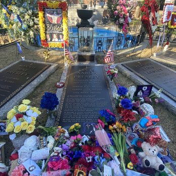 Graceland Mansion - Adorning fans leave flowers and mementos at the grave. - Museums Near Me - Memphis, Tennessee