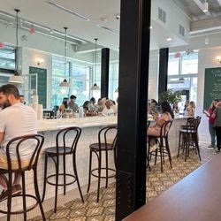 Tatte Bakery & Cafe | Garden City - Bar seating with bag hooks