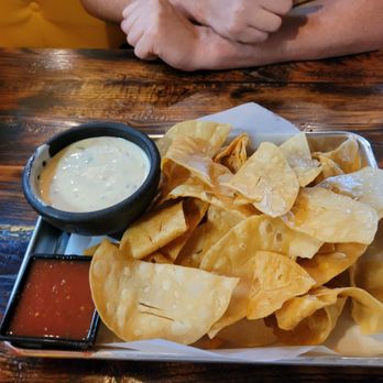 Hacienda Tacos - a plate of nachos and dipping sauce - Tacos Near Me - Oklahoma City, Oklahoma