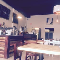 Love Food Central - Spacious, clean and inviting interior with sofas inviting you to stay awhile longer and enjoy some reading, tea, and or desert.