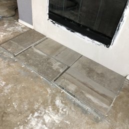 Checking to see if we like entryway tile on fireplace as opposed to the two by two all over the fireplace.