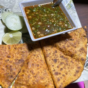 Mi Ranchito - Birria quesadilla.  Brisket consommé with brisket cilantro and onions. Fresh cucumber slices and lime. - Latin American Near Me - Trenton, New Jersey