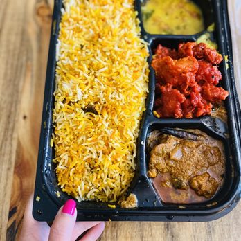 Hyderabad House - Goat Lunch Box!! Hand for scale. It's massive. With Chicken 65 and  Curry Leaf Chicken - Indian Near Me - Centennial, Colorado