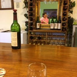 a glass of wine on a table a glass of wine on a table