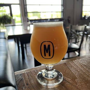 Monolithic Brewing - a glass of beer on a table - Breweries Near Me - Omaha, Nebraska