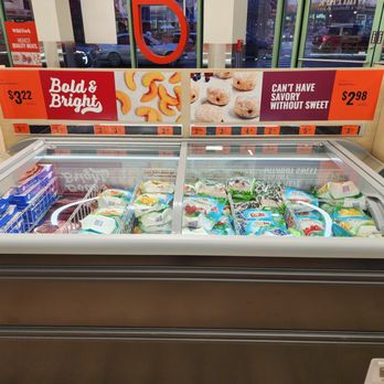 Wild Fork - Frozen dairy items are stored in a glass-top freezer at Wild Fork, with price tags and promotional signage visible above. - Seafood Markets Near Me - Oak Park, Illinois
