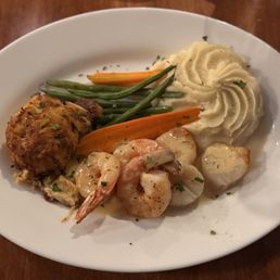 Seafood Trio - Crabcake, shrimp, scallops, mashed potatoes, and seasonal vegetables. Seafood Trio - Crabcake, shrimp, scallops, mashed potatoes, and seasonal vegetables.
