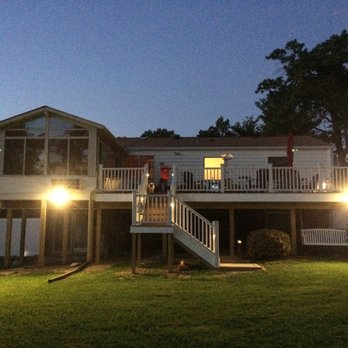 Amaya Home Improvement - a man standing on a deck at night - General Contractors Near Me Amaya Home Improvement - a man standing on a deck at night - General Contractors Near Me