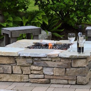 Choice Landscapes - a stone fire pit with a bottle of wine - Landscaping Near Me - Mount Vernon, Washington