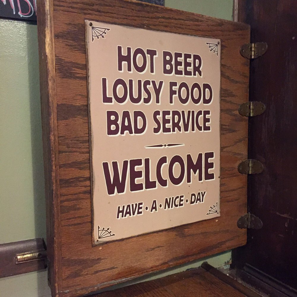 Cooper's - a sign that reads hot beer, lousy food, bad service, welcome have a nice day - Nightlife Near Me - Nevada City, California Cooper's - a sign that reads hot beer, lousy food, bad service, welcome have a nice day - Nightlife Near Me - Nevada City, California