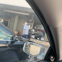 The postmaster shuffling around the parking lot while customers wait in front of a locked post office, during regular business hours. The postmaster shuffling around the parking lot while customers wait in front of a locked post office, during regular business hours.