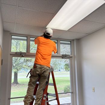 VoltEdge Electrical Solutions - Technician replacing an exit light fixture at a commercial office building. - Electricians Near Me - Gulfport, Mississippi VoltEdge Electrical Solutions - Technician replacing an exit light fixture at a commercial office building. - Electricians Near Me - Gulfport, Mississippi